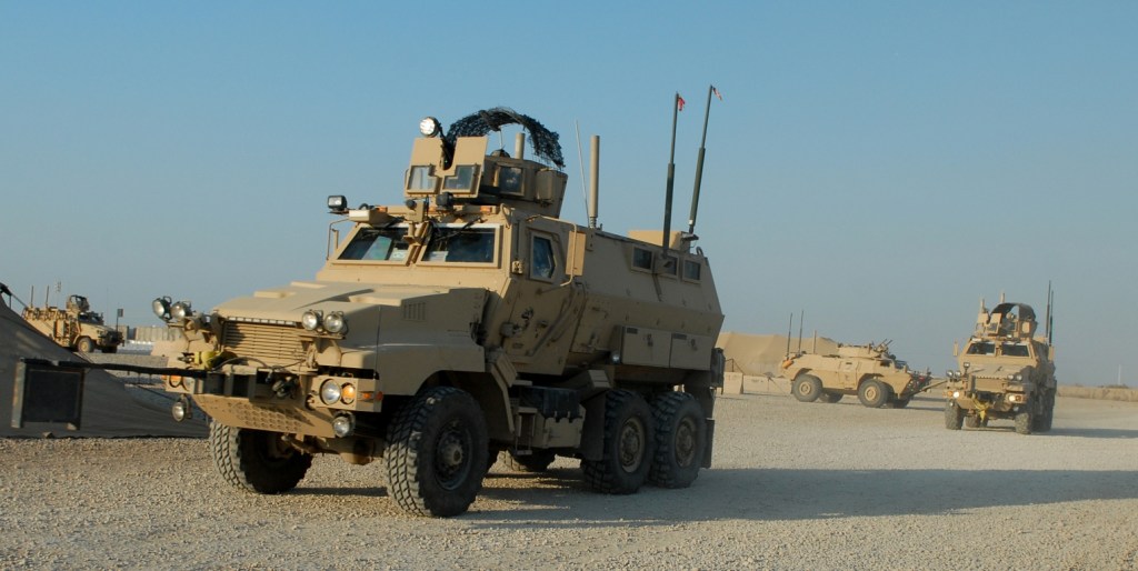 U.S. Soldiers assigned to Delta Company, 1st Battalion, 186th Infantry Regiment, 41st Infantry Brigade Combat Team, head out for a mission aboard Caiman mine-resistant, ambush-protected vehicles and an M1117 Guardian armored security vehicle, background, at Camp Adder, Iraq, Oct. 31, 2009. (U.S. Army photo by Spc. Anita VanderMolen/Released)